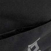 Kumite backpack close-up of black fabric with small diagonal logo detail