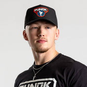 Black performance fighter hat worn by a person, featuring the PUNOK front logo.