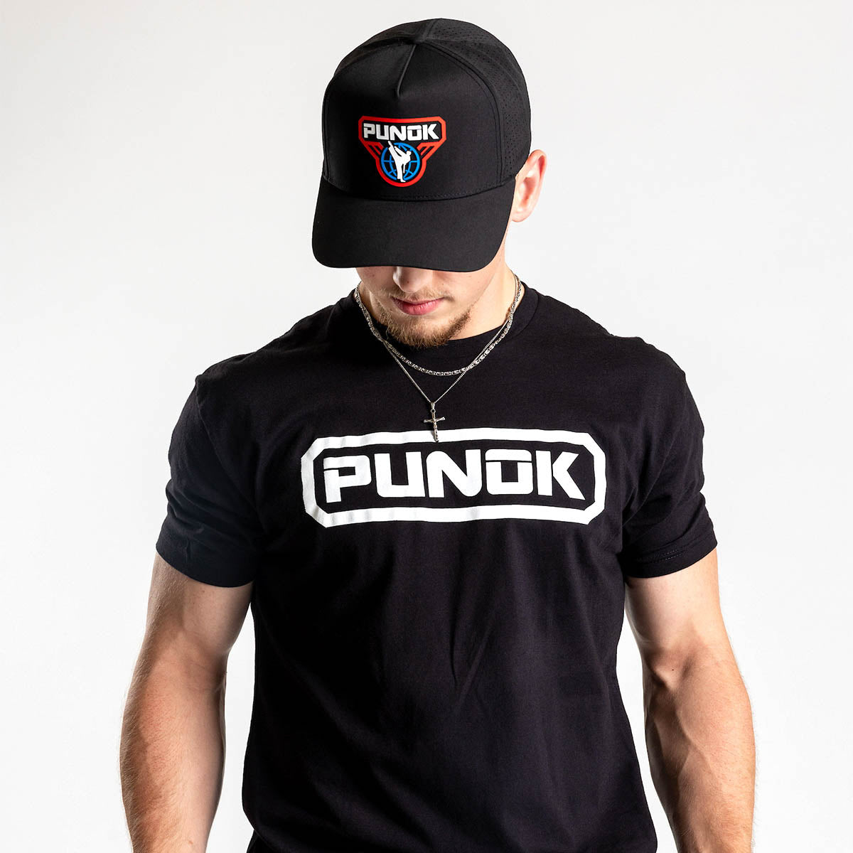 Black performance fighter hat with PUNOK logo on the front, worn facing down.