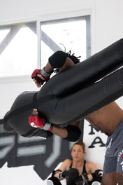 Black inflatable grappling dummy with padded arms and legs for training