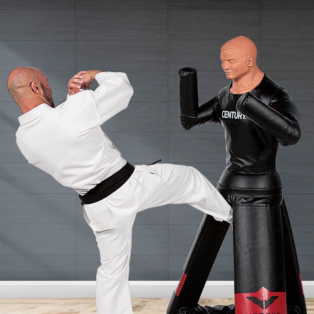 Black punching training mannequin with red emblem, full body with raised fists