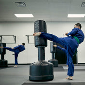 Wavemaster freestanding punch bag with black cylinder and base, training stance in gym