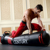 Black Versys VS.1 training bag lying on floor, with red seam and branding.
