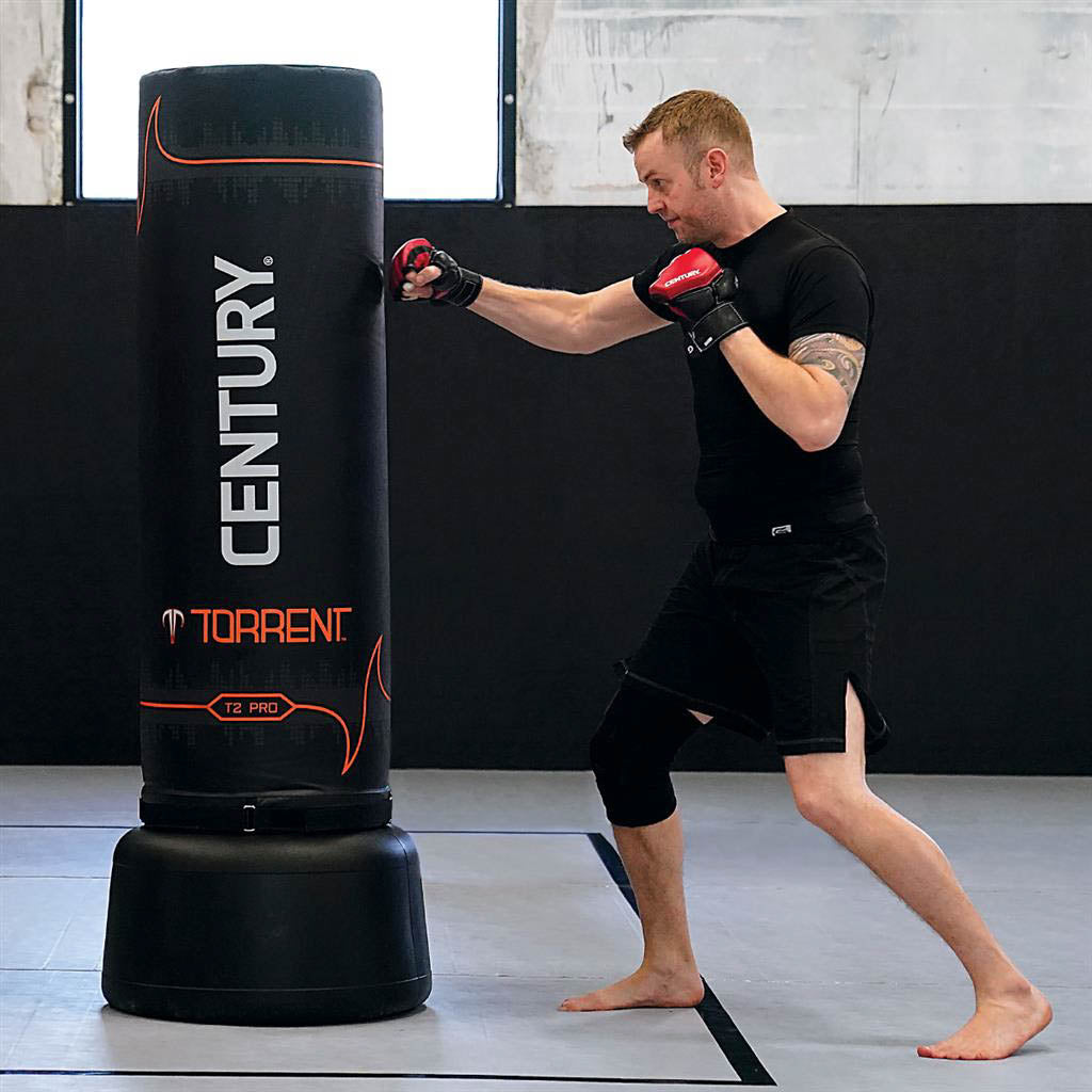 Black Century Torrent T2 Pro freestanding punching bag during pad strikes