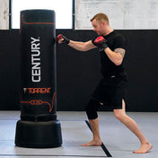 Black Century Torrent T2 Pro freestanding punching bag during pad strikes