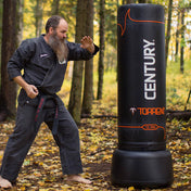 Black Century Torrent T2 Pro freestanding punching bag with red logo markings outdoors