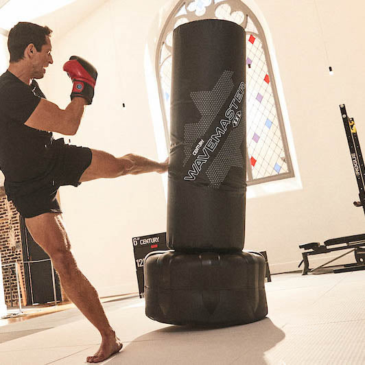 Black freestanding punching target with tall top bag and rounded padded base