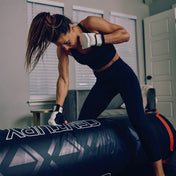 Black punching bag top with red strap detail and geometric graphic accents