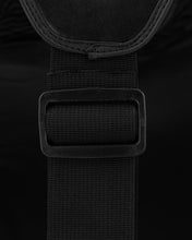 Black belly pad fastening strap with rectangular hook-and-loop patch close-up