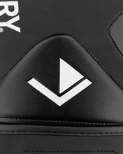 Black boxing glove close-up with white logo mark on padded knuckle area