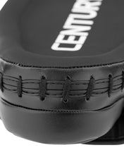 Close-up of black catcher's mitt branding and stitched leather panel at the seam