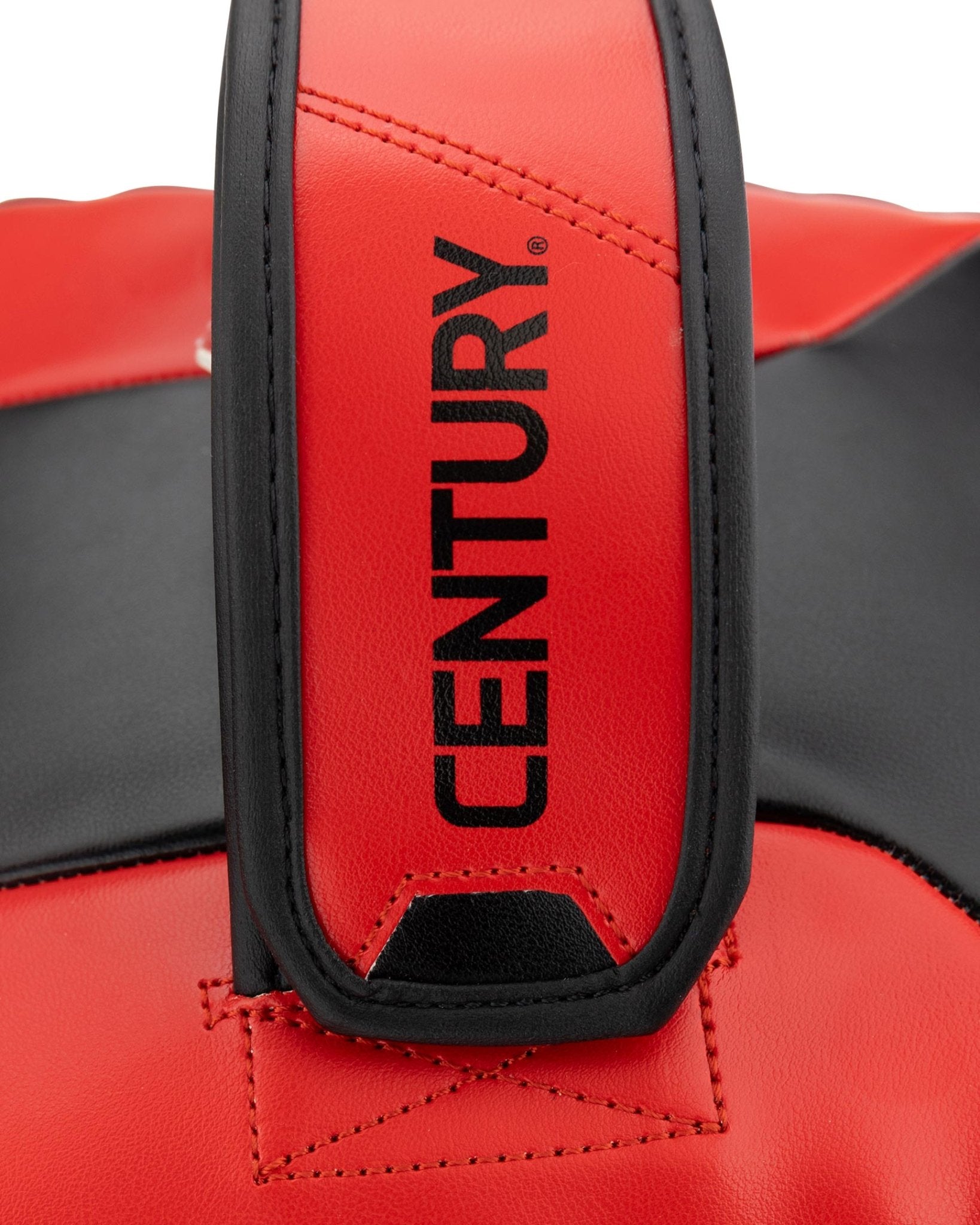 Close-up of red and black Muay Thai pad showing Century logo on wrist strap