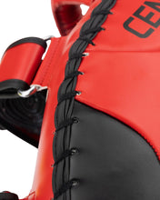 Close-up of red and black Muay Thai pad lacing with Century branding on surface