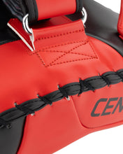 Close-up of red Muay Thai pad with top fastener strap and Century logo
