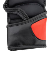 Black boxing glove thumb area with red side panel and stitched seams