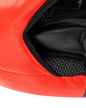 Close-up of red striking pad edge with black interior lining on focus mitt