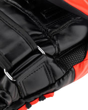 Close-up of black padded wrist strap stitching on red and black focus mitt