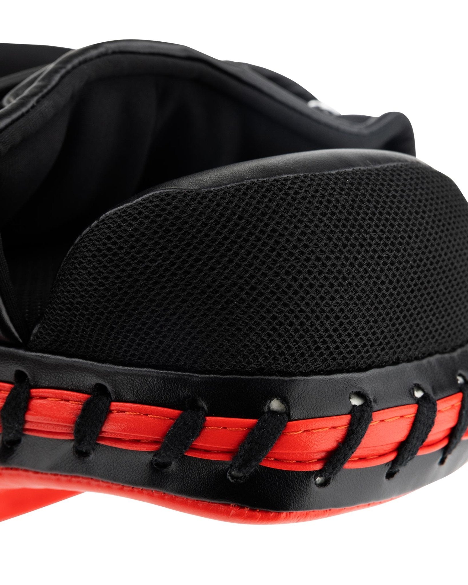 Close-up of black textured footbed area and red edge stitching on focus mitt