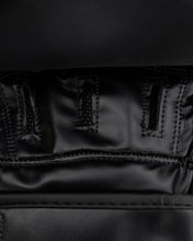 Close-up of black leather palm panel and reinforced seams on focus mitt