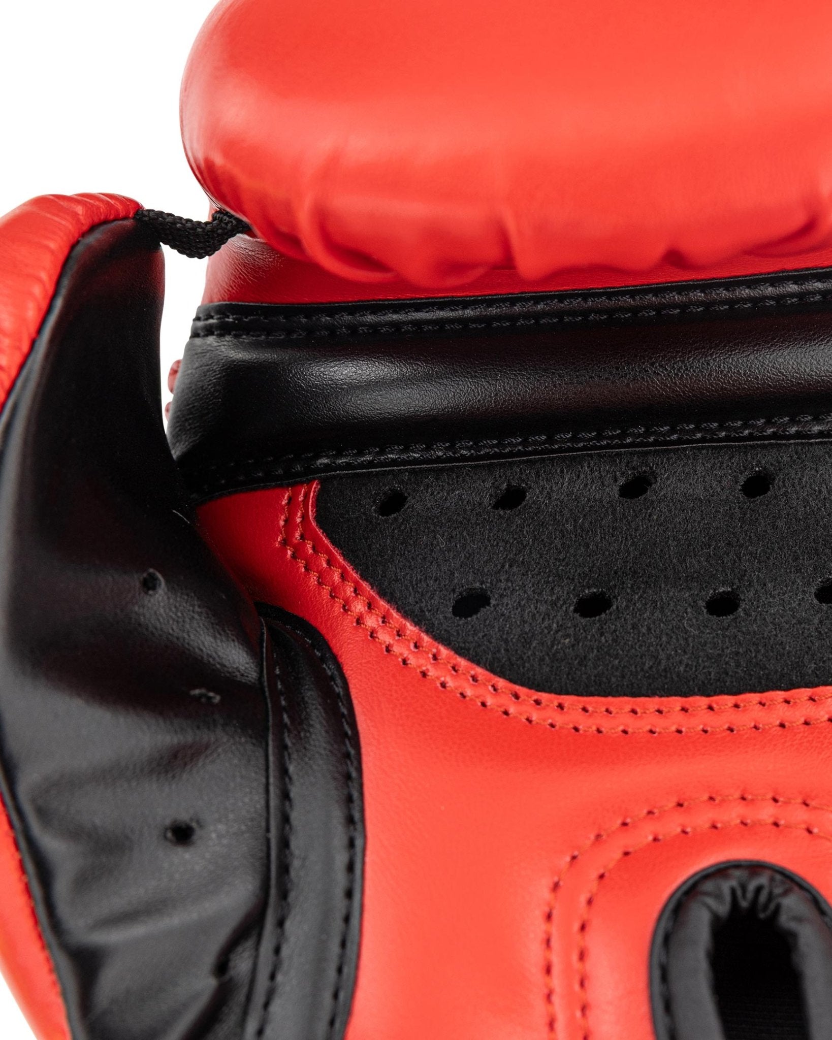 Close-up red and black heavy bag glove with perforated palm padding