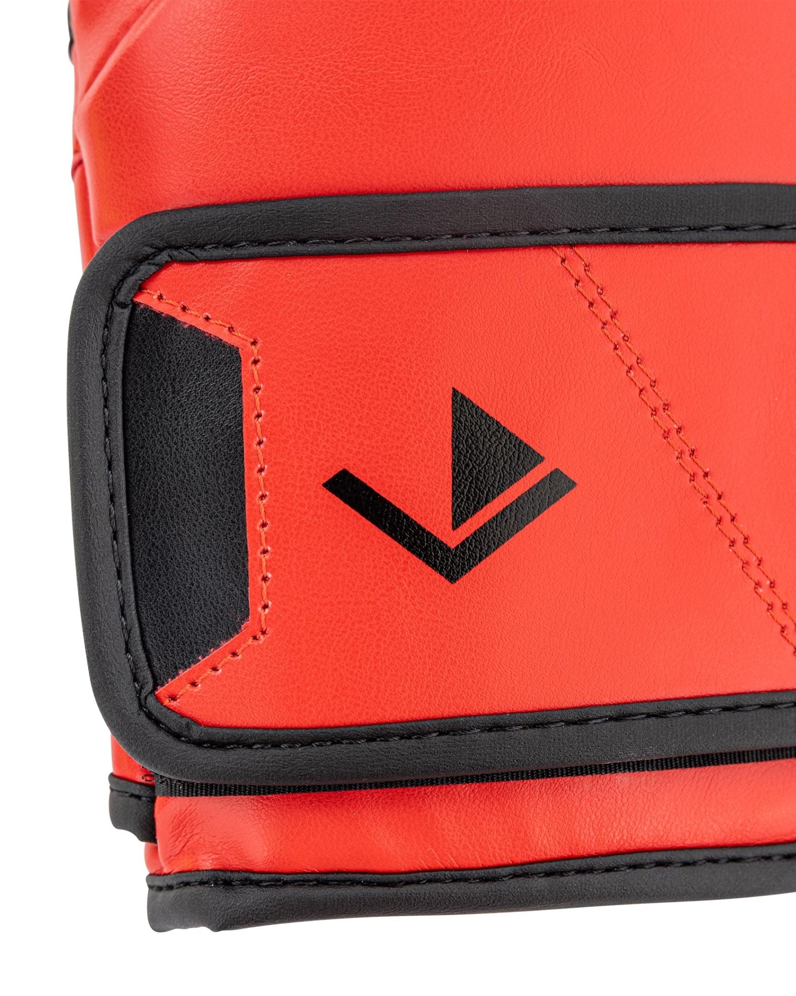 Close-up red boxing glove wrist panel with black trim and V-style logo