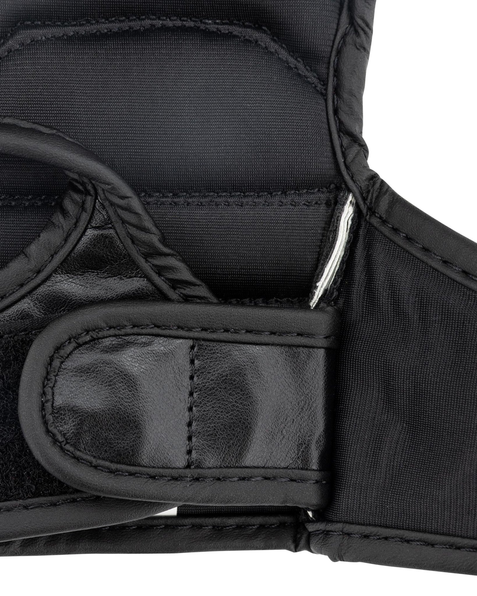Youth fight gloves close-up: knuckle protection with stitched wrist strap detail
