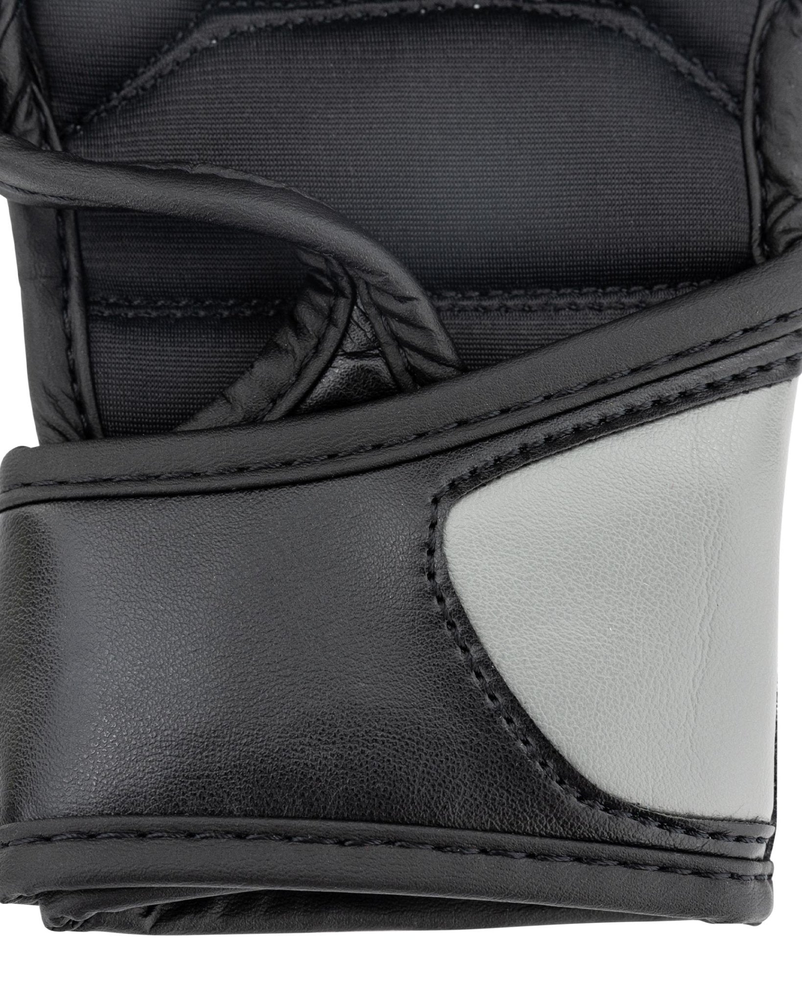 Youth fight gloves close-up: black and light grey side panel with stitched edge seam