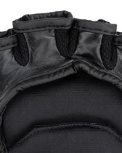 Youth fight gloves close-up: padded thumb seam and black interior mesh