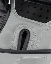 Grey youth heavy bag glove close-up of black perforated palm guard and thumb seam