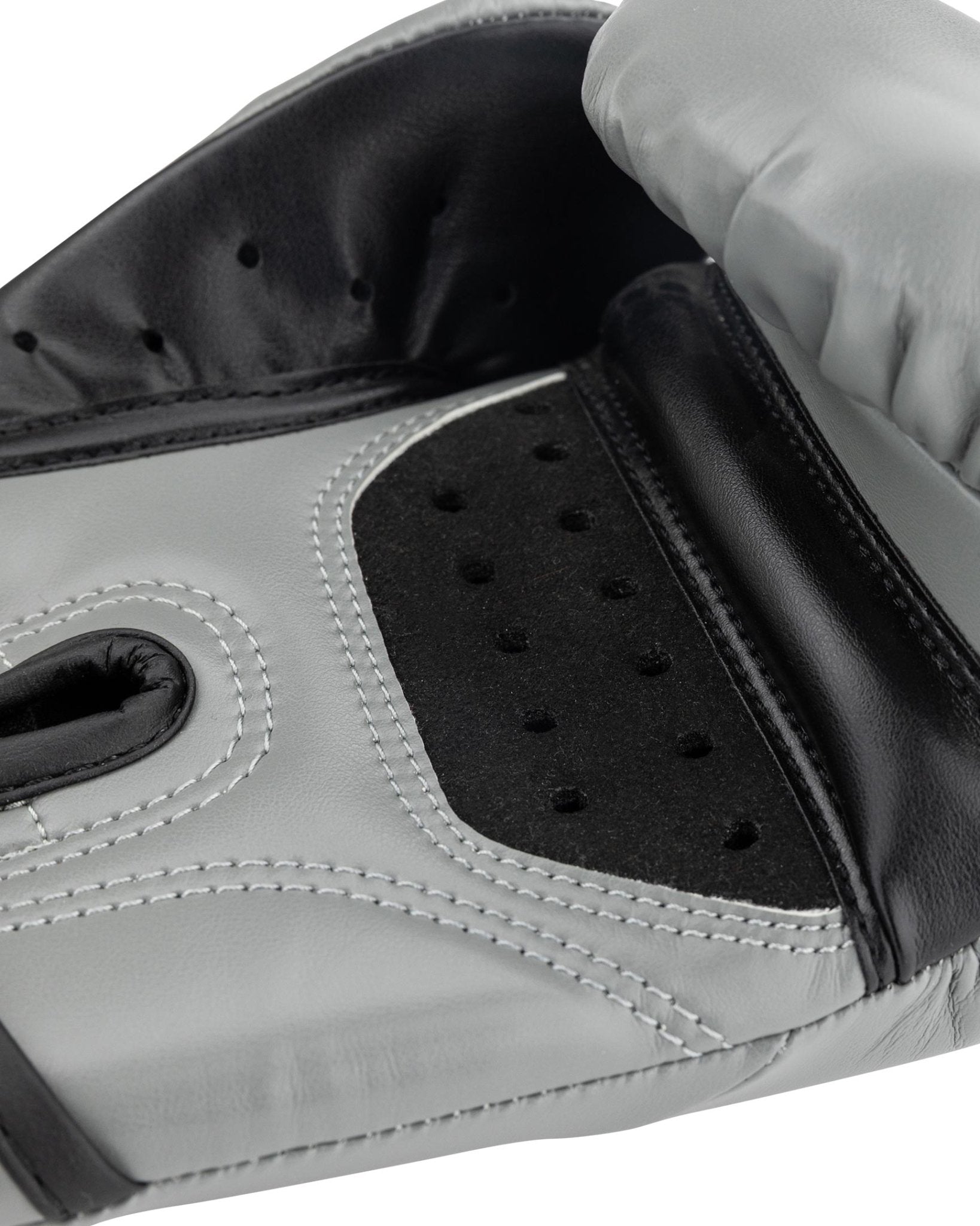 Grey youth heavy bag boxing glove close-up of black perforated striking surface