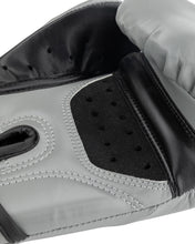 Grey youth heavy bag boxing glove close-up of black perforated striking surface