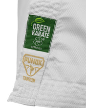 Close-up of Green Karate and Punok TAKYON patches on white karate pants