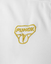 Close-up of Punok logo patch on white karate uniform fabric