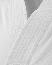 Close-up of textured white karate uniform fabric with stitched seam lines