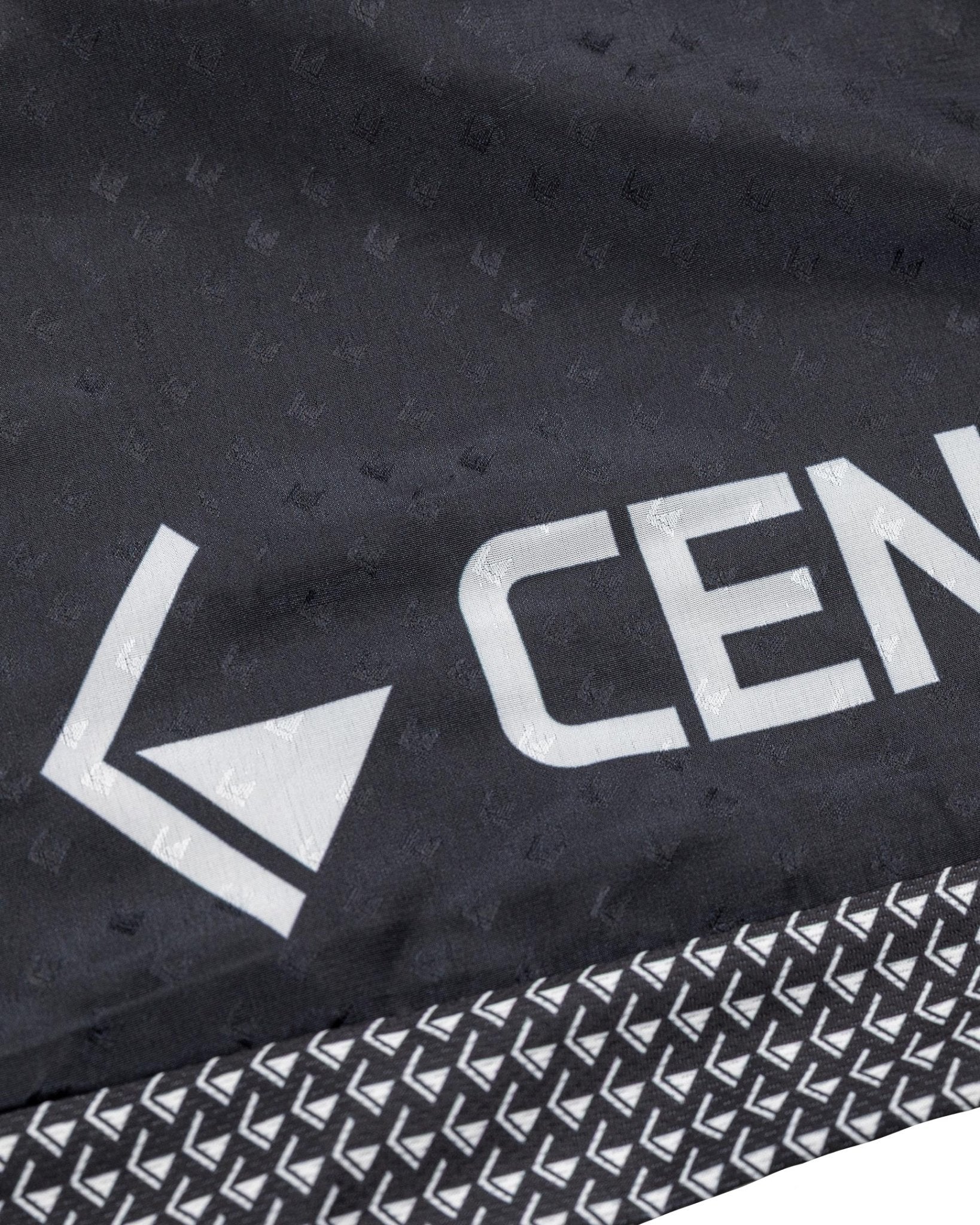 Tenacity pants fabric in dark with large “CEN” text and arrow-style logo