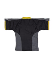 Black martial arts top with yellow trim around neckline and textured side panels