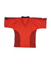 Red martial arts top with black-trimmed neckline and textured side panels