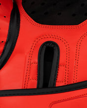 Close-up of red kickboxing glove palm padding with black ventilation insert and stitching