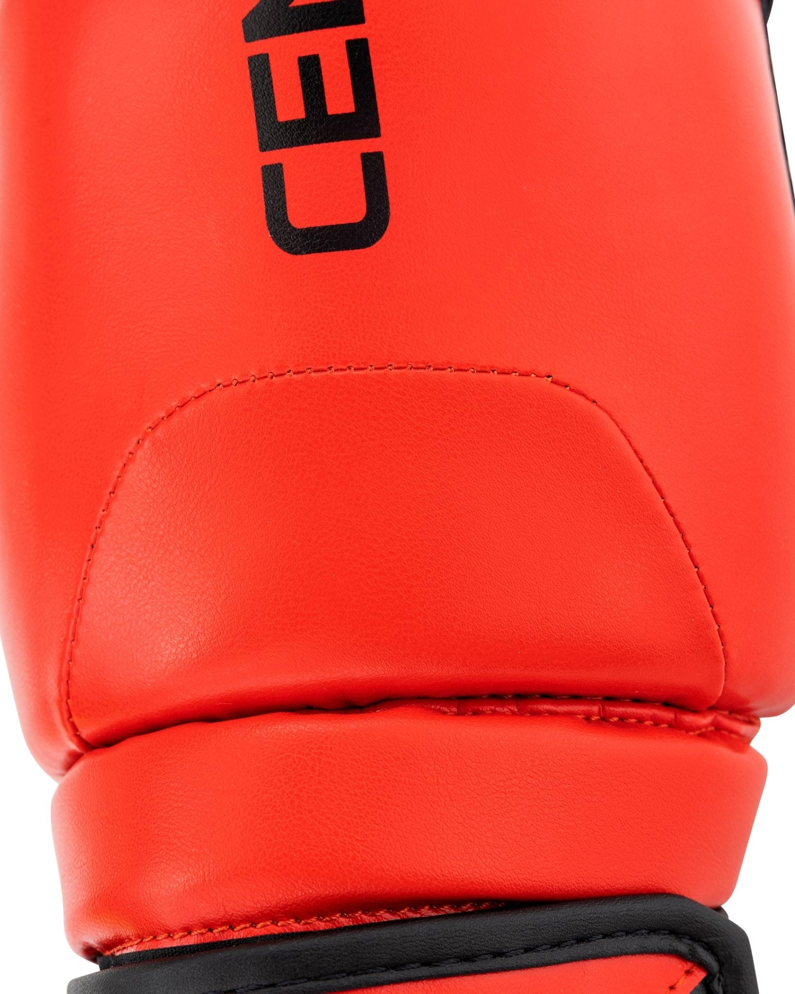 Red boxing glove with curved palm padding and black wrist band