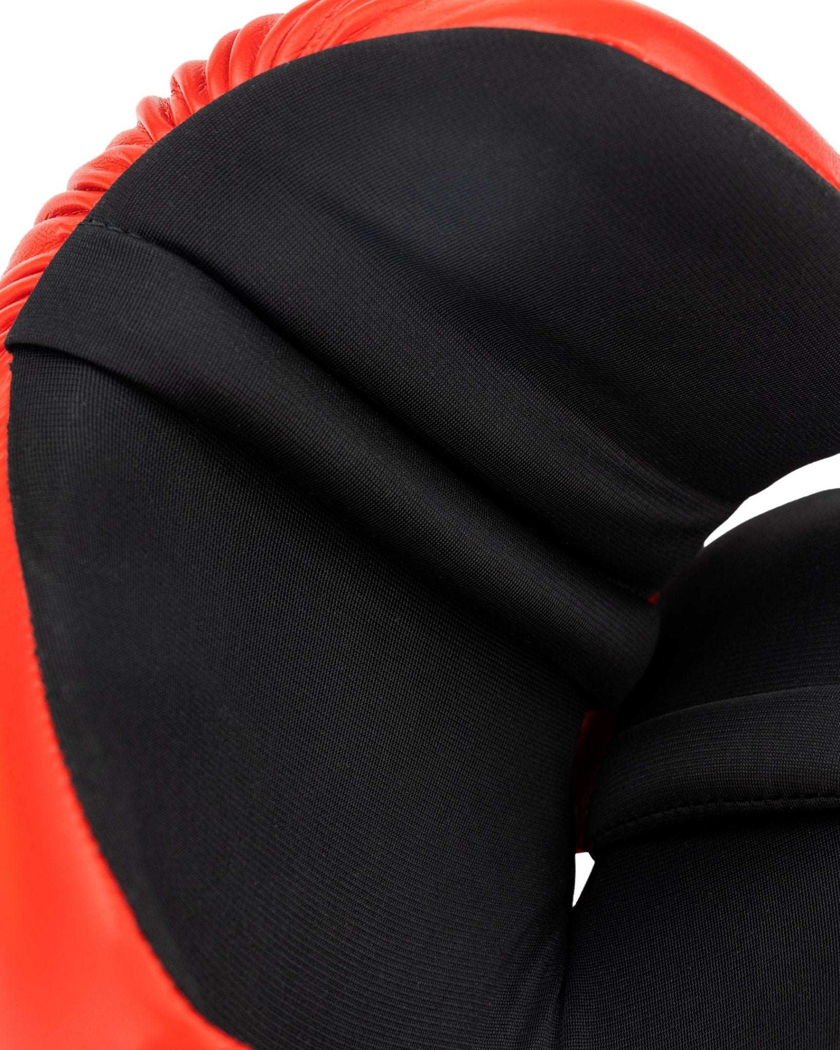 Black inner hand padding on a red boxing glove