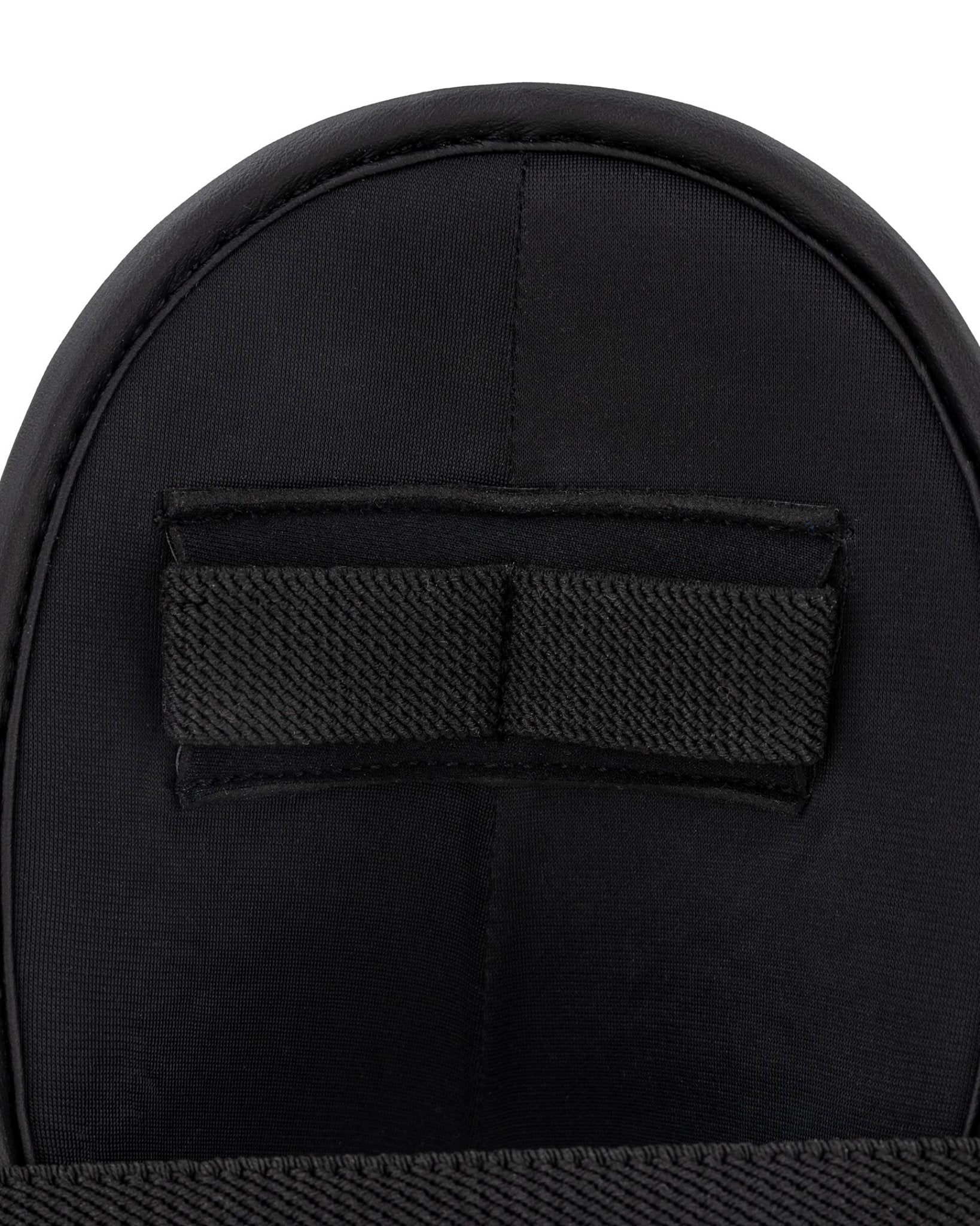 Black padded ankle kick with centered hook-and-loop strap panel