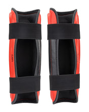WAKO Drive shin guards in red and black, LEFT side label visible and black fastening strap.