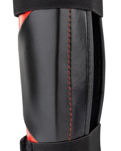 WAKO Drive shin guards close-up with black shell, red stitching, and textured surface.