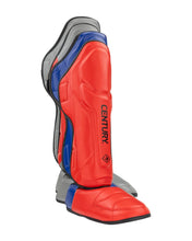 Red, blue, and grey shin instep guards with CENTURY logo and curved padding.