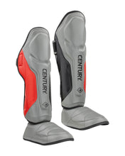 Grey and red shin instep guards with black interior panel and CENTURY logo.
