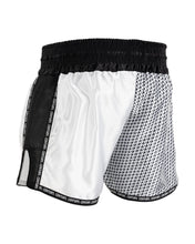 White and black kickboxing shorts with textured paneling and elastic waistband